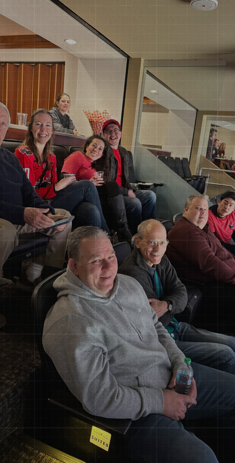 Credence-Team-Image Credence team members smiling together while enjoying a sporting event from a stadium suite.